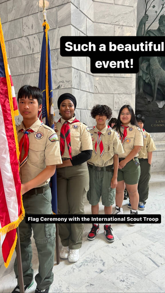 Members of an international scout troop stand together during a flag ceremony, representing unity, service, and the diverse refugee community in Utah supported by Utah Refugee Connection.