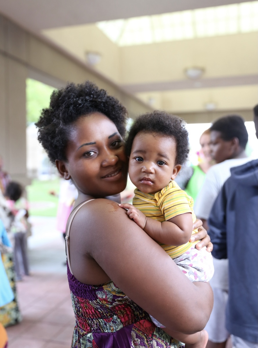 A refugee mother holds her baby during a Utah Refugee Connection gathering in Utah. Utah Refugee Connection supports refugee mothers through maternal health resources, community care, and family support programs.